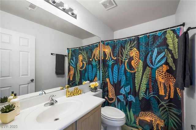 bathroom with visible vents, a shower with shower curtain, toilet, and vanity