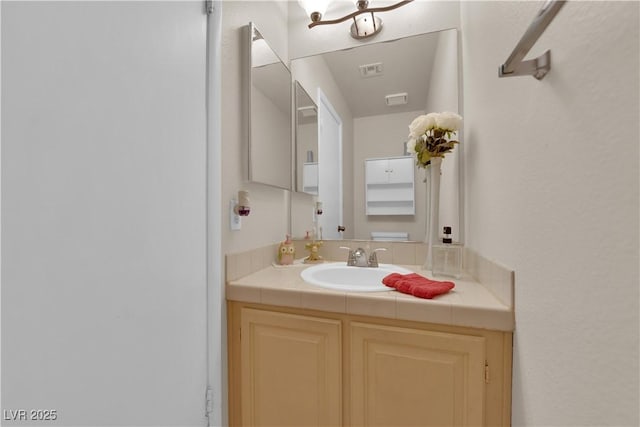 bathroom with vanity and visible vents