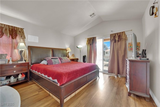 bedroom with access to outside, vaulted ceiling, visible vents, and light wood-type flooring