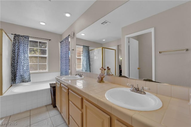 bathroom featuring a sink, tile patterned floors, a shower stall, and double vanity