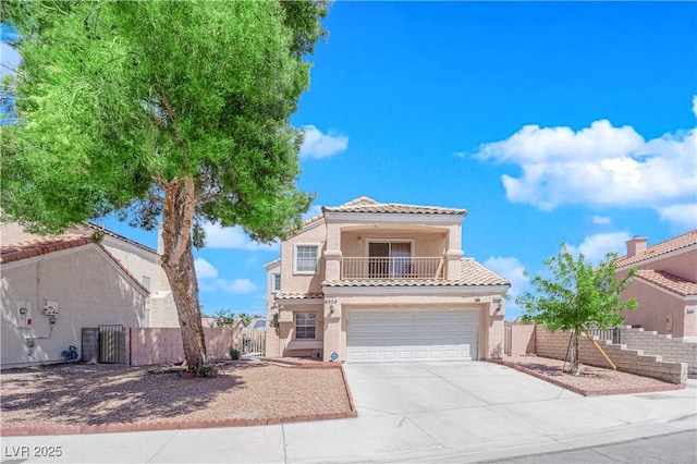 mediterranean / spanish-style house featuring an attached garage, a tile roof, stucco siding, concrete driveway, and a balcony