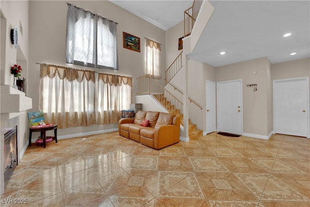 living room with baseboards, recessed lighting, a towering ceiling, and stairway