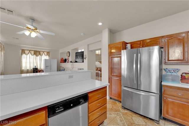 kitchen with light countertops, stainless steel appliances, a ceiling fan, and visible vents