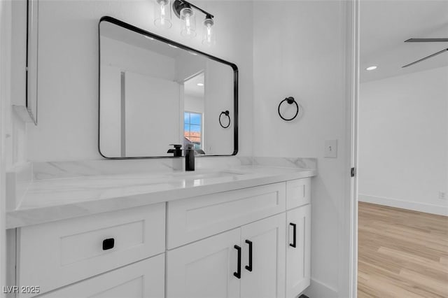 8725 Russet Hills Ct, Las Vegas, NV 89147 - bathroom with vanity, wood finished floors, baseboards, and a ceiling fan