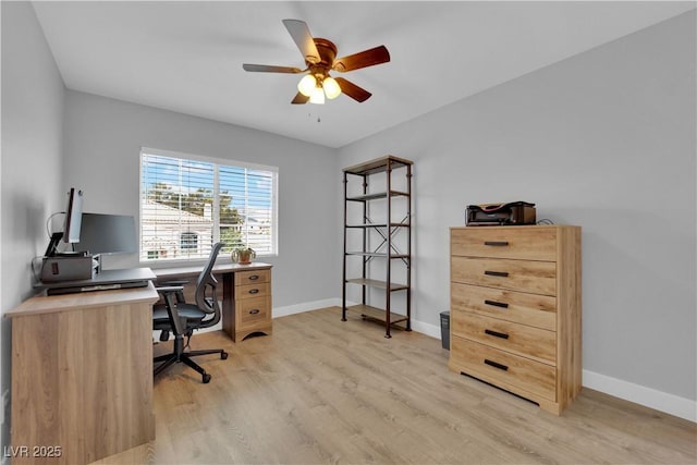 home office featuring a ceiling fan, baseboards, and light wood-style flooring