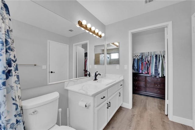 full bath with vanity, visible vents, wood finished floors, toilet, and baseboards