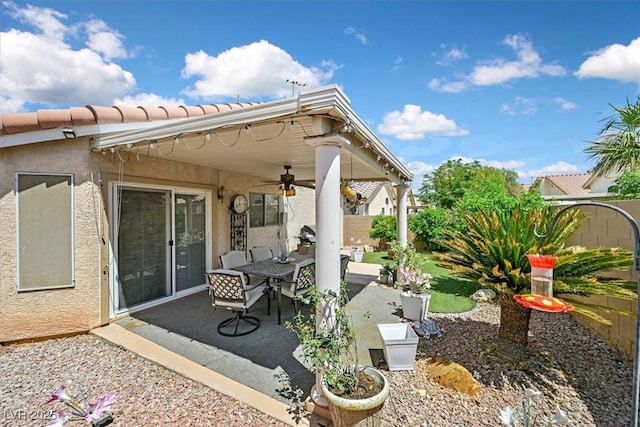 view of patio with a ceiling fan, a fenced backyard, and outdoor dining space