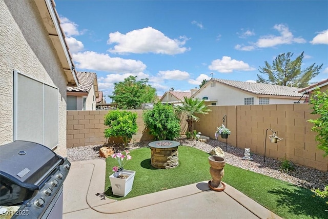 view of yard with a fenced backyard and an outdoor fire pit