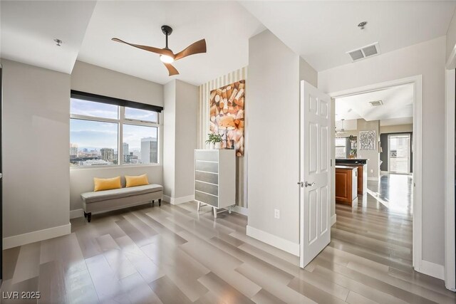 150 Las Vegas Blvd Unit 1507, Las Vegas, NV 89101 - sitting room featuring visible vents, baseboards, light wood finished floors, and ceiling fan