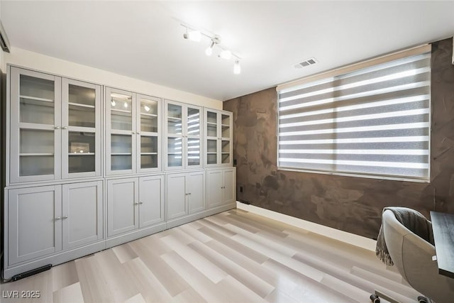 150 Las Vegas Blvd Unit 1507, Las Vegas, NV 89101 - unfurnished office featuring track lighting, baseboards, light wood-style flooring, and visible vents