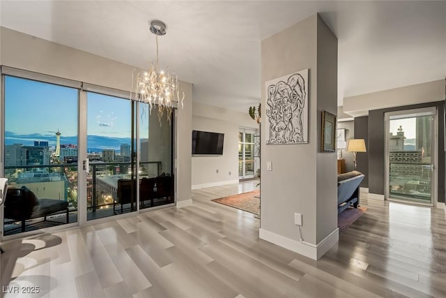 150 Las Vegas Blvd Unit 1507, Las Vegas, NV 89101 - dining area with baseboards, wood finished floors, and a chandelier