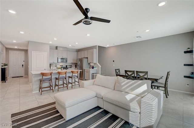 living room with recessed lighting, a ceiling fan, light tile patterned floors, and stairway