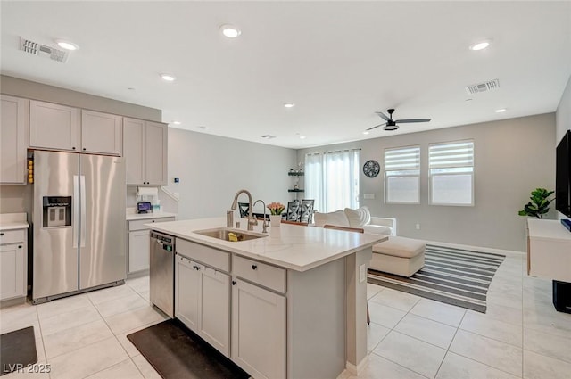 kitchen with visible vents, a ceiling fan, light tile patterned flooring, a sink, and appliances with stainless steel finishes