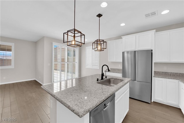 kitchen with a sink, appliances with stainless steel finishes, a wealth of natural light, and visible vents