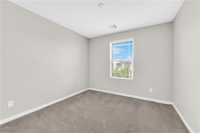 carpeted empty room with baseboards and visible vents