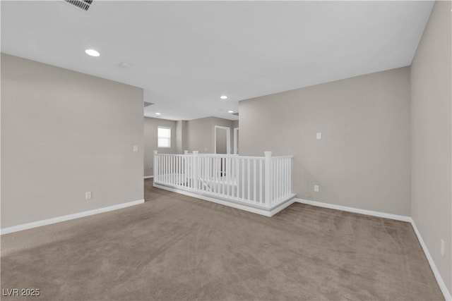 carpeted empty room featuring baseboards, recessed lighting, and visible vents