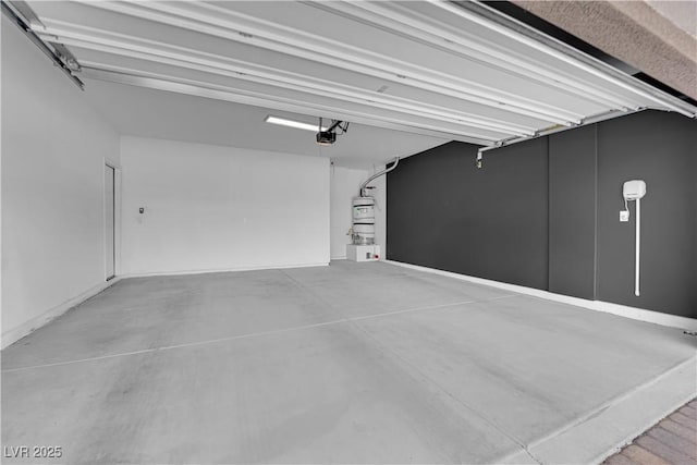 garage featuring a garage door opener and water heater