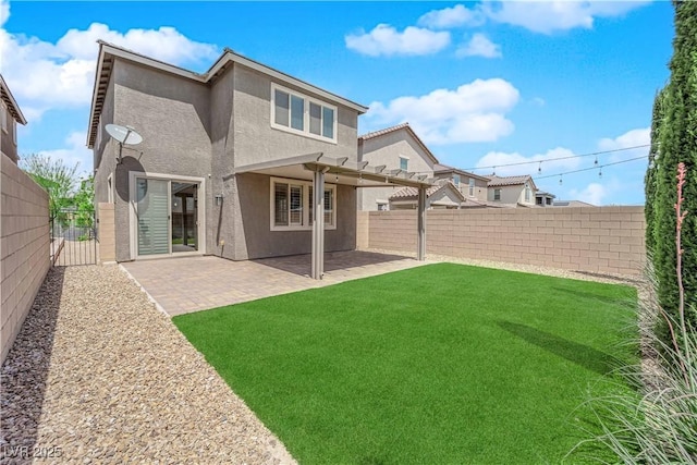 rear view of house with a pergola, stucco siding, a fenced backyard, a patio area, and a yard