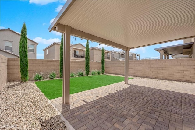 view of patio / terrace featuring a residential view and a fenced backyard