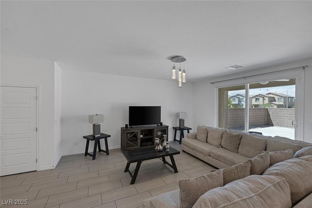 living room featuring baseboards and visible vents