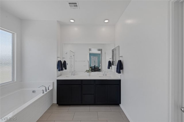 full bath featuring plenty of natural light, a sink, a bath, and visible vents