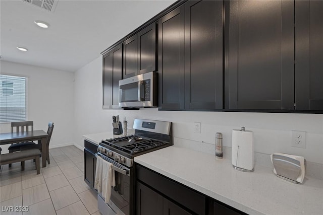 kitchen featuring visible vents, appliances with stainless steel finishes, light countertops, baseboards, and recessed lighting