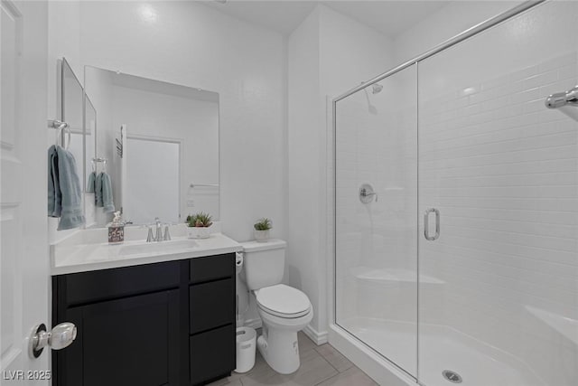 full bath with vanity, tile patterned floors, a stall shower, and toilet