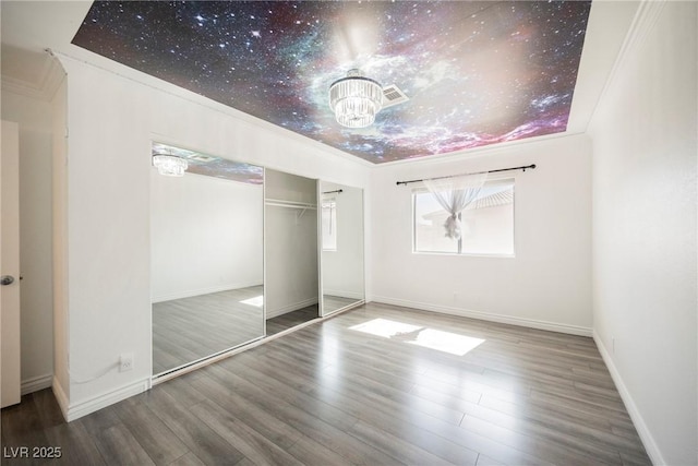 unfurnished bedroom with baseboards and wood finished floors