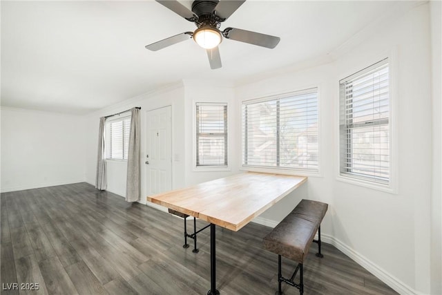 dining area with crown molding, baseboards, dark wood finished floors, and ceiling fan