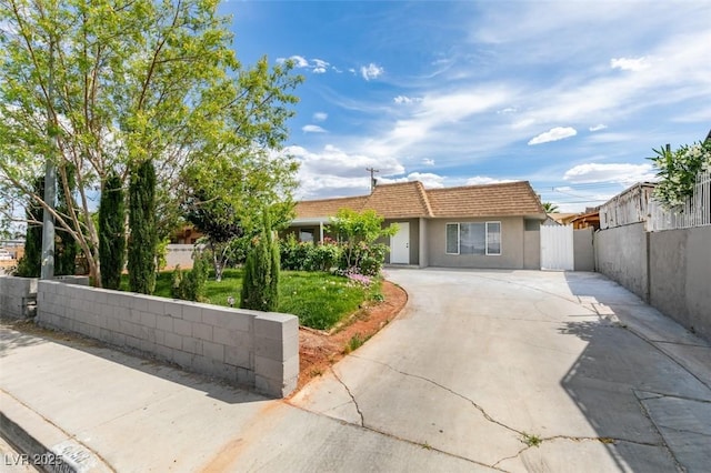 4393 Swandale Ave, Las Vegas, NV 89121 - ranch-style home featuring concrete driveway, a tiled roof, fence private yard, and stucco siding