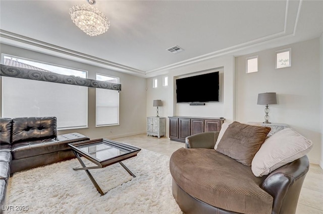 tiled living room with a chandelier, baseboards, visible vents, and a tray ceiling