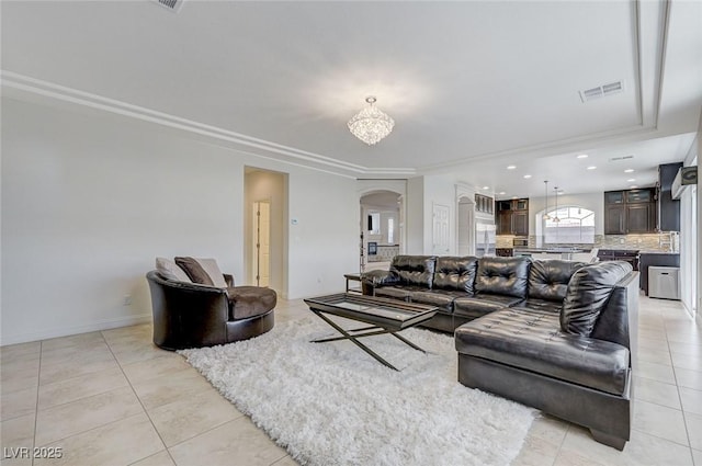 living area with visible vents, an inviting chandelier, recessed lighting, arched walkways, and light tile patterned floors