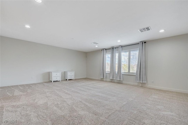 unfurnished room with visible vents, recessed lighting, carpet, and baseboards