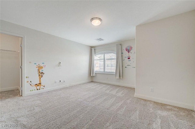 carpeted spare room with baseboards and visible vents