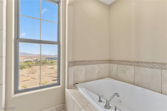 bathroom with plenty of natural light and a tub with jets