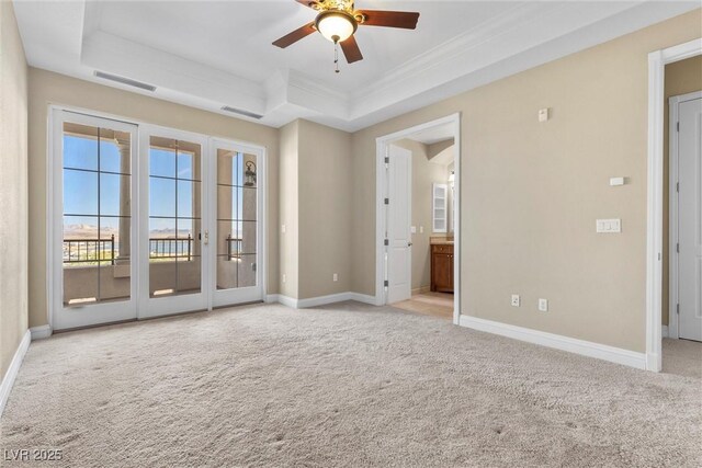 20 Via Visione Unit 105, Henderson, NV 89011 - unfurnished room featuring carpet floors, a ceiling fan, baseboards, a tray ceiling, and visible vents