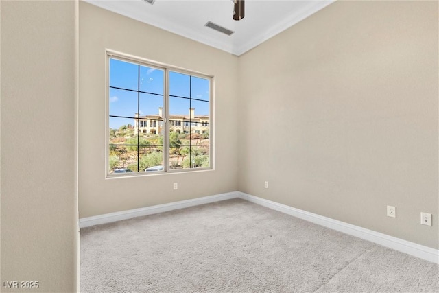 unfurnished room with ceiling fan, carpet floors, baseboards, visible vents, and ornamental molding