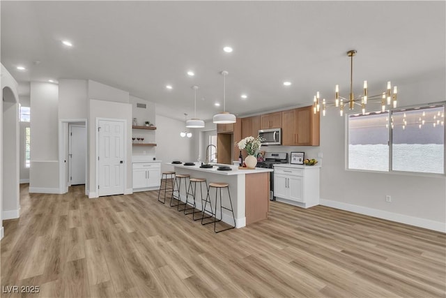 kitchen featuring baseboards, open shelves, light wood-type flooring, and stainless steel appliances