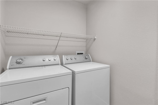 washroom featuring laundry area and washer and clothes dryer