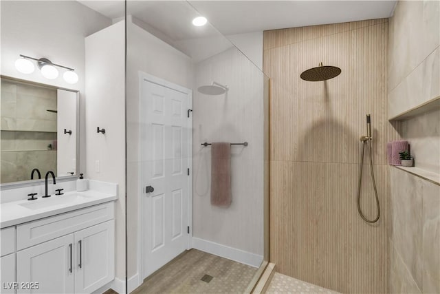 full bathroom featuring a walk in shower and vanity
