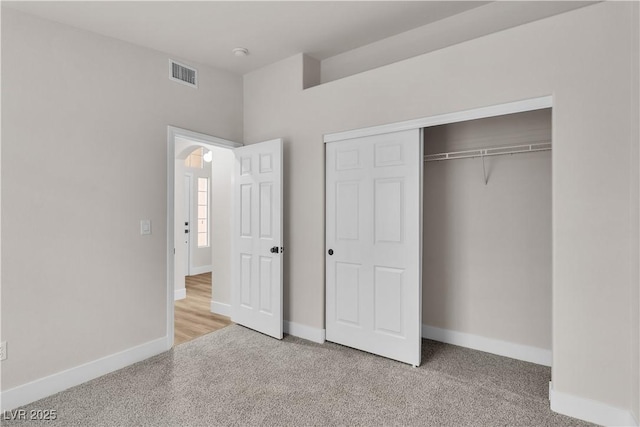 unfurnished bedroom with visible vents, baseboards, carpet floors, and a closet