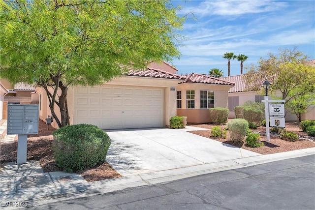 mediterranean / spanish-style house featuring a tiled roof, an attached garage, concrete driveway, and stucco siding