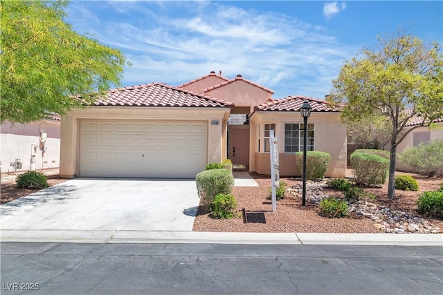 mediterranean / spanish-style home featuring an attached garage, stucco siding, driveway, and a tile roof