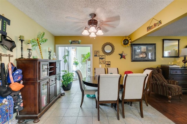 dining room with a ceiling fan, a textured ceiling, and light tile patterned flooring