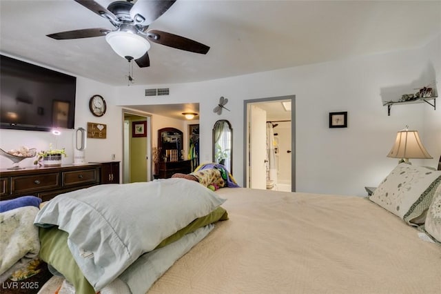 bedroom with visible vents, ceiling fan, and ensuite bath
