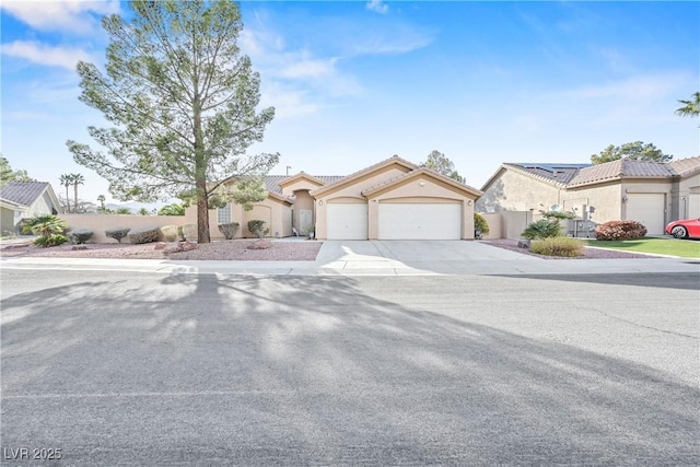 view of front of home featuring fence, an attached garage, stucco siding, a tiled roof, and driveway
