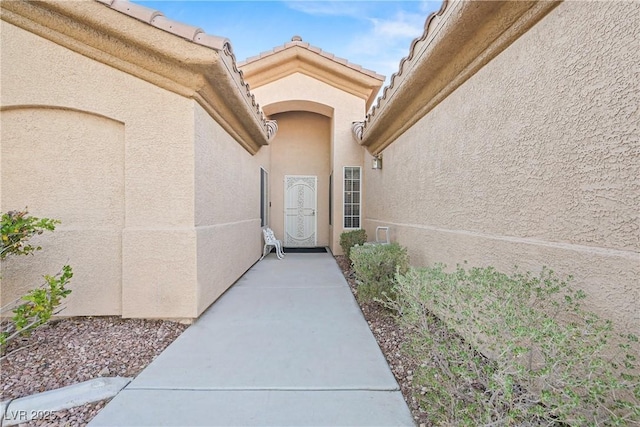 doorway to property with stucco siding
