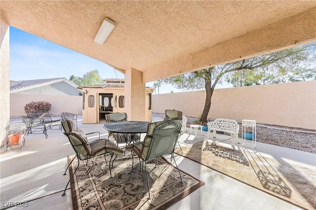 view of patio with a fenced backyard and outdoor dining space