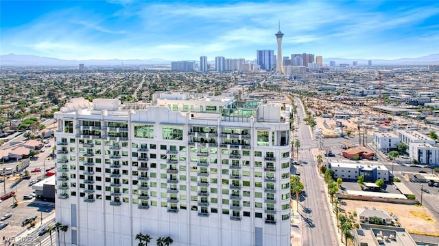drone / aerial view featuring a view of city and a mountain view
