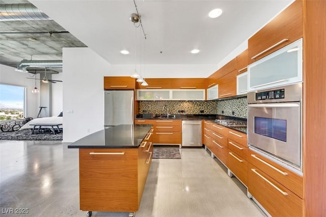 kitchen featuring a sink, modern cabinets, backsplash, and stainless steel appliances